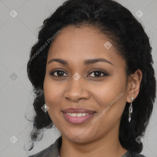 Joyful black young-adult female with long  black hair and brown eyes