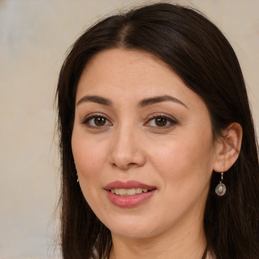 Joyful white adult female with long  brown hair and brown eyes