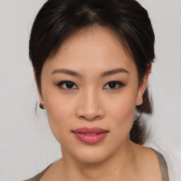 Joyful asian young-adult female with medium  brown hair and brown eyes