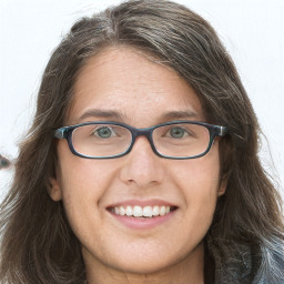 Joyful white young-adult female with long  brown hair and blue eyes