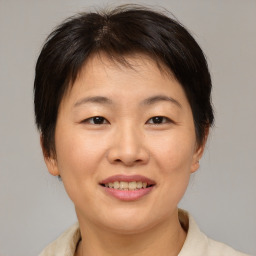 Joyful asian adult female with medium  brown hair and brown eyes