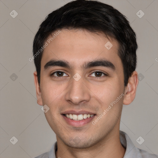 Joyful white young-adult male with short  black hair and brown eyes