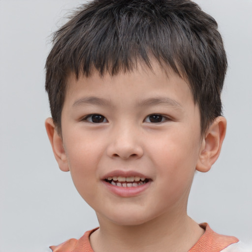 Joyful white child male with short  brown hair and brown eyes