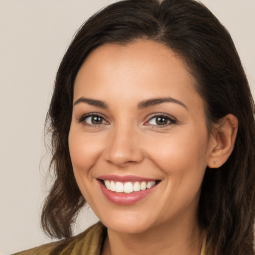 Joyful white young-adult female with long  brown hair and brown eyes