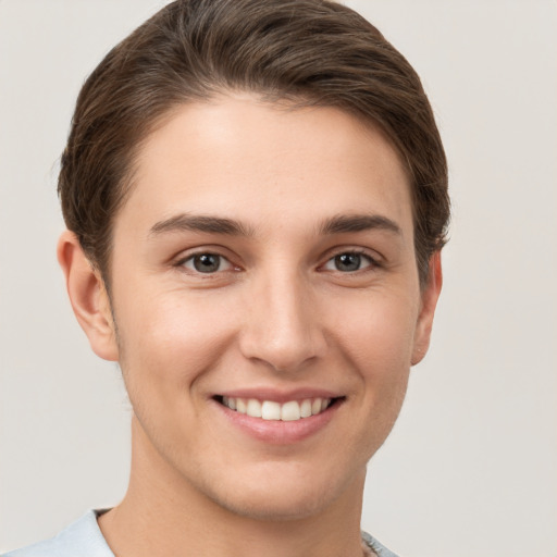 Joyful white young-adult female with short  brown hair and grey eyes