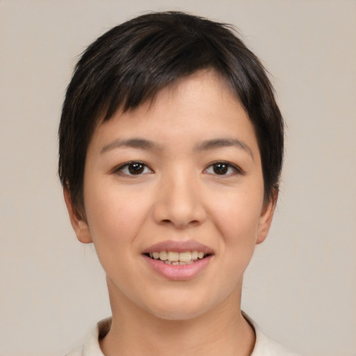 Joyful asian young-adult female with short  brown hair and brown eyes