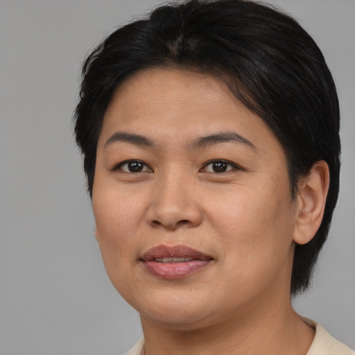 Joyful asian young-adult female with short  brown hair and brown eyes