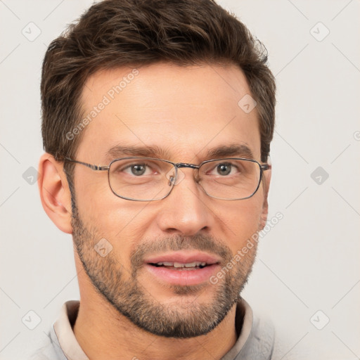 Joyful white adult male with short  brown hair and brown eyes