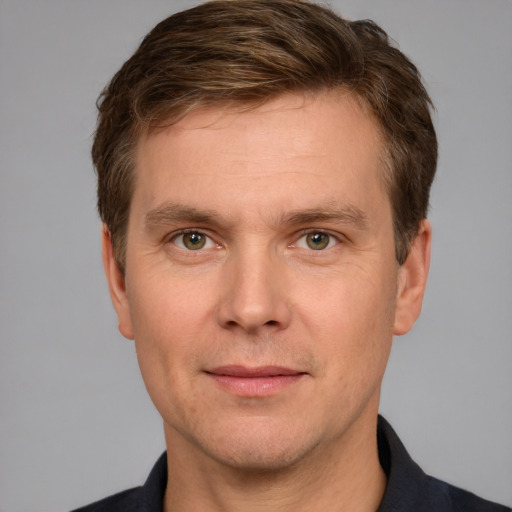 Joyful white adult male with short  brown hair and grey eyes