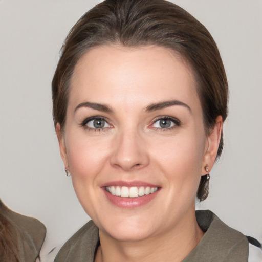 Joyful white young-adult female with medium  brown hair and brown eyes