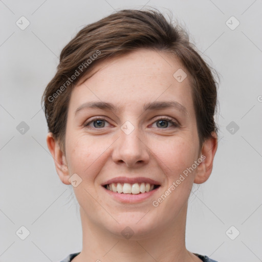 Joyful white young-adult female with short  brown hair and grey eyes