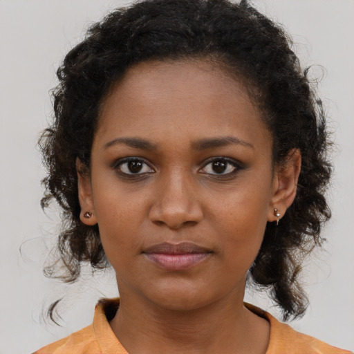 Neutral black young-adult female with medium  brown hair and brown eyes