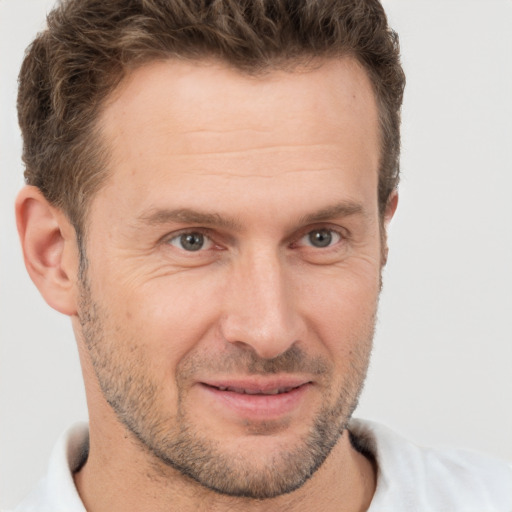 Joyful white adult male with short  brown hair and brown eyes