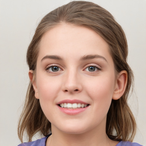 Joyful white young-adult female with medium  brown hair and blue eyes