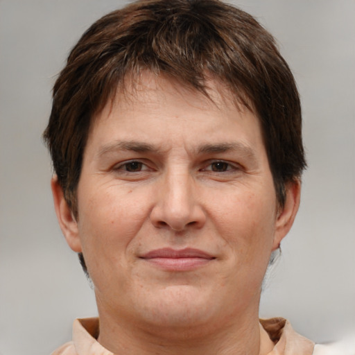 Joyful white adult female with short  brown hair and brown eyes