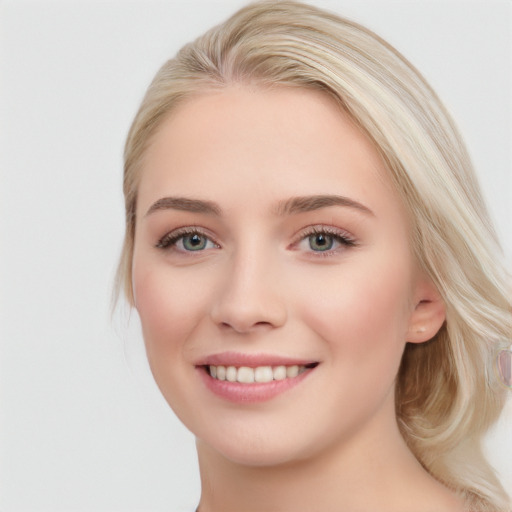 Joyful white young-adult female with long  brown hair and blue eyes