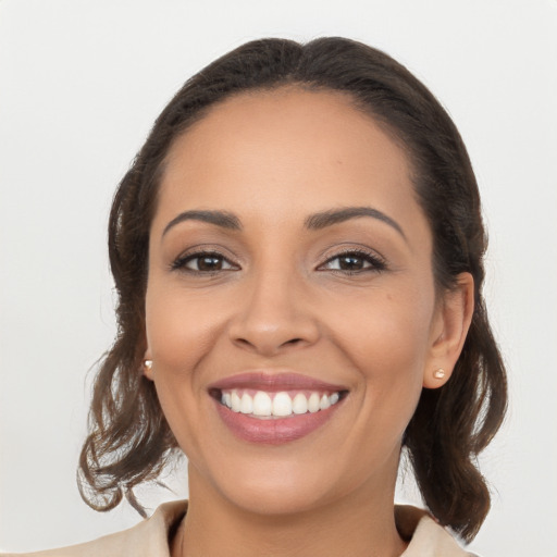 Joyful latino young-adult female with long  brown hair and brown eyes