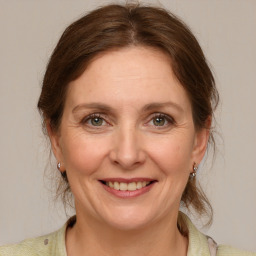 Joyful white adult female with medium  brown hair and grey eyes