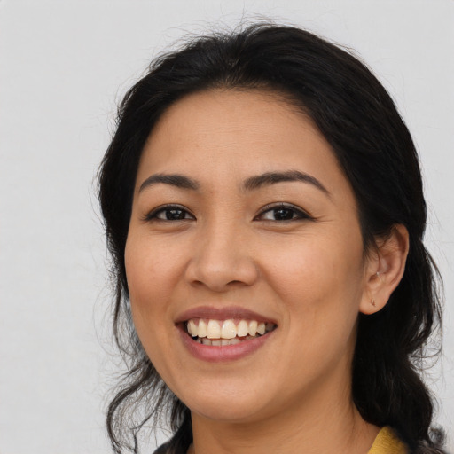 Joyful asian young-adult female with long  black hair and brown eyes