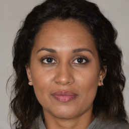 Joyful black adult female with medium  brown hair and brown eyes