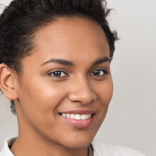 Joyful latino young-adult female with short  brown hair and brown eyes