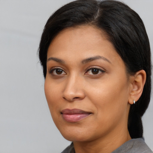 Joyful black young-adult female with medium  black hair and brown eyes