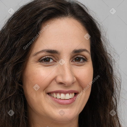 Joyful white adult female with long  brown hair and brown eyes