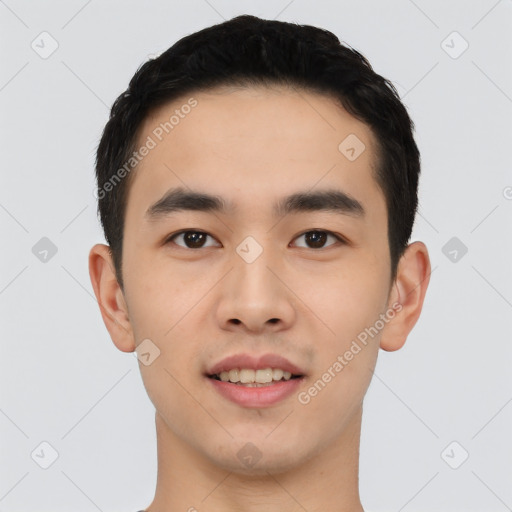 Joyful asian young-adult male with short  black hair and brown eyes