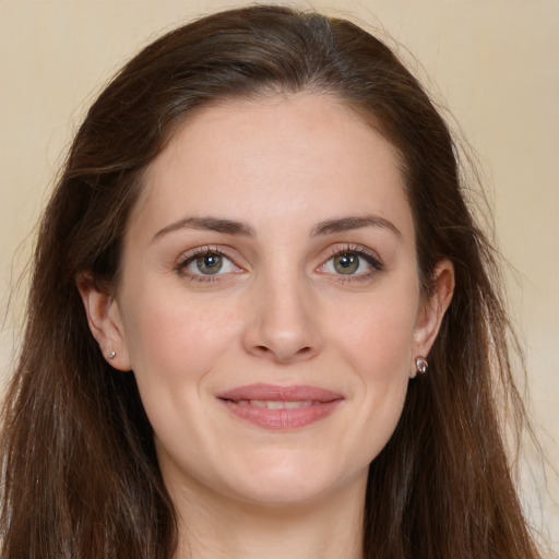 Joyful white young-adult female with long  brown hair and green eyes