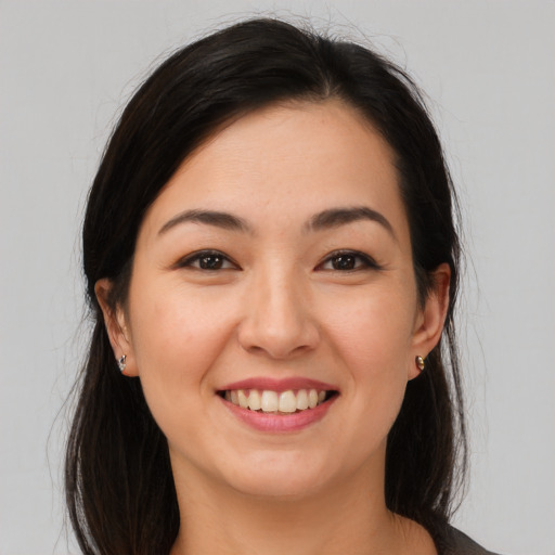 Joyful asian young-adult female with long  brown hair and brown eyes