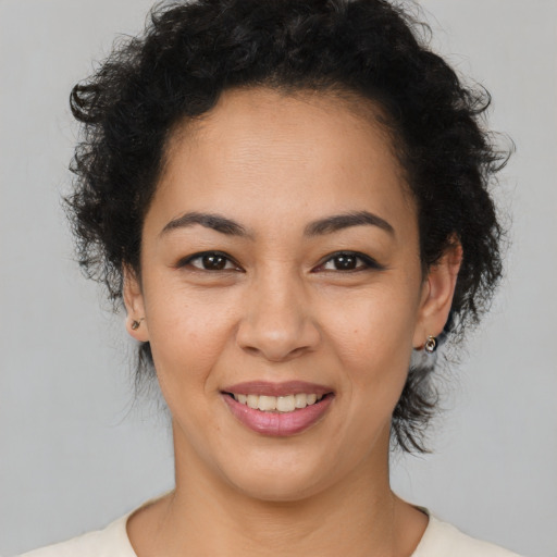 Joyful latino young-adult female with medium  brown hair and brown eyes