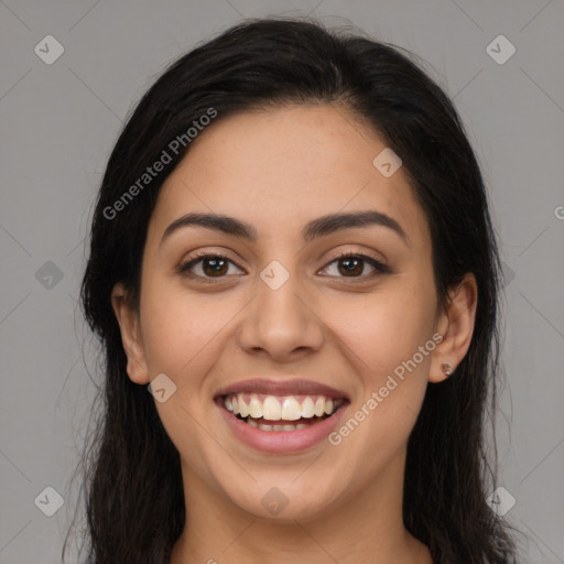 Joyful latino young-adult female with long  brown hair and brown eyes