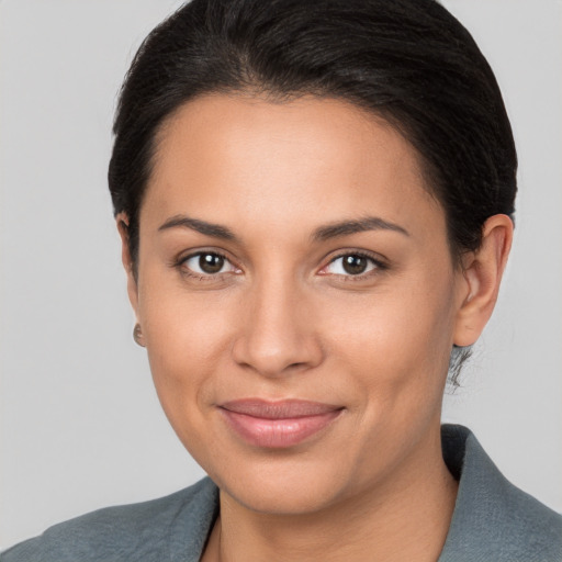 Joyful latino young-adult female with short  brown hair and brown eyes