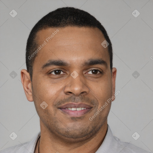 Joyful latino young-adult male with short  brown hair and brown eyes