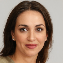 Joyful white young-adult female with medium  brown hair and brown eyes