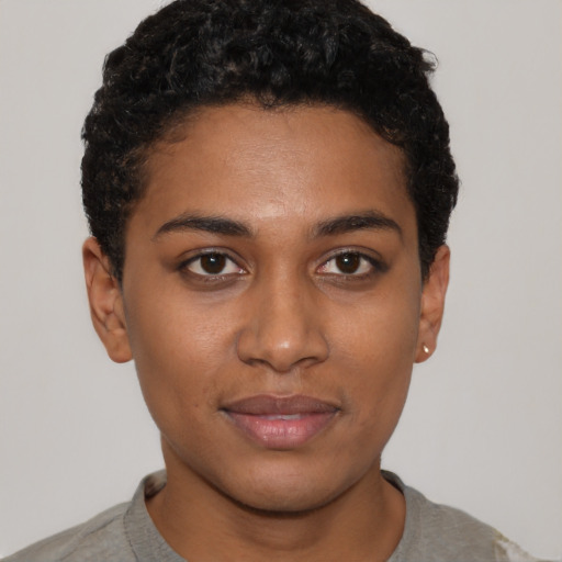 Joyful black young-adult female with short  brown hair and brown eyes