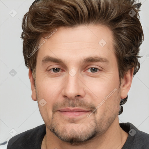 Joyful white adult male with short  brown hair and grey eyes