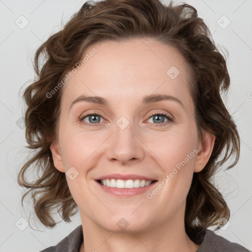 Joyful white young-adult female with medium  brown hair and blue eyes