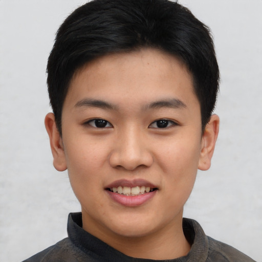 Joyful asian young-adult male with short  brown hair and brown eyes