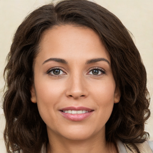 Joyful white young-adult female with long  brown hair and brown eyes