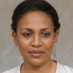 Joyful black adult female with short  brown hair and brown eyes