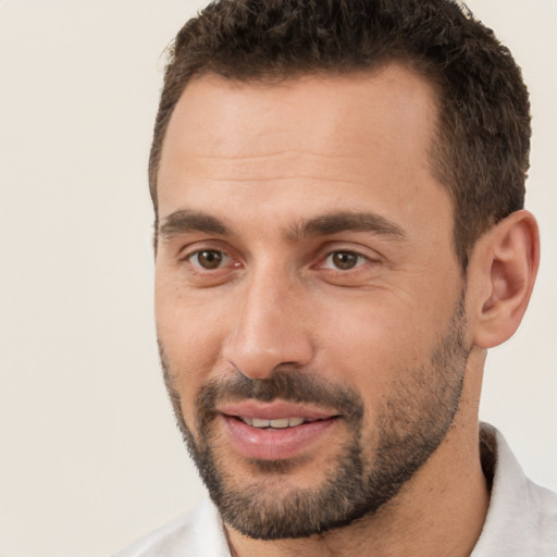 Joyful white young-adult male with short  brown hair and brown eyes