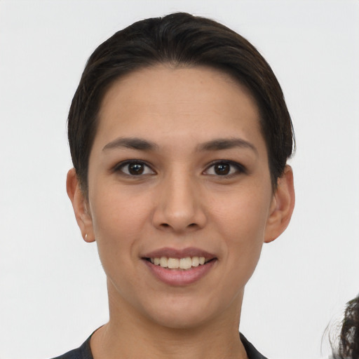 Joyful white young-adult female with short  black hair and brown eyes