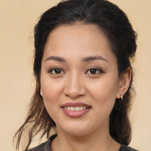 Joyful latino young-adult female with long  brown hair and brown eyes