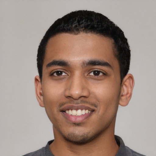 Joyful latino young-adult male with short  black hair and brown eyes