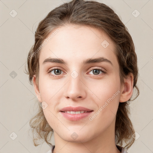 Joyful white young-adult female with medium  brown hair and green eyes