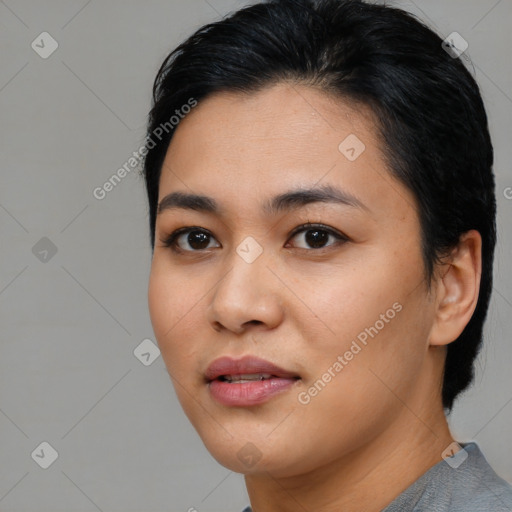 Joyful asian young-adult female with medium  black hair and brown eyes