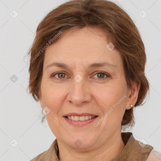 Joyful white adult female with medium  brown hair and grey eyes