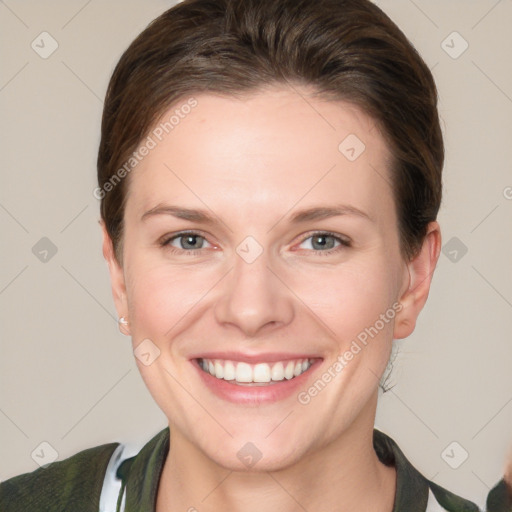 Joyful white young-adult female with short  brown hair and grey eyes