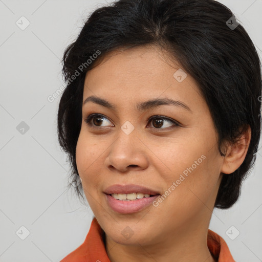 Joyful latino young-adult female with medium  brown hair and brown eyes